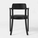 A modern black dining chair with a curved wooden frame, padded black seat and backrest, shown from the front on a light gray studio background.