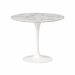 Round marble table with a white base on a white background