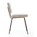 A modern dining chair with a light beige textured fabric seat and backrest, supported by a slim black metal frame and legs, shown from a side profile on a white background.
