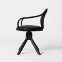 A modern black swivel dining chair with a curved armrest, padded seat, and three splayed legs, photographed against a seamless light gray studio background.