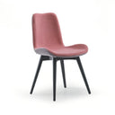 A modern dining chair with a dusty rose pink upholstered seat and back, supported by four black tapered legs, shown against a plain white background.