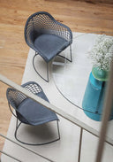 Top-down view of two Midj Guapa P M CU Armchairs dark gray woven leather seats black metal frames