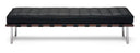 A modern tufted daybed with a black leather cushion, a dark wood slatted base, and chrome legs, shown against a plain white background.
