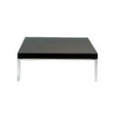 Black square table with silver legs on a white background