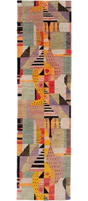 A long rectangular area rug with an abstract geometric pattern in muted pink, sage green, beige, orange, yellow, black, and purple, shown flat against a white background.