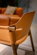 Close-up of Suite AP L CU Lounge Chair by Midj brown leather and dark wood frame from the back