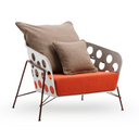 A modern outdoor lounge chair with a rust-orange textured seat cushion, a white frame with circular cutouts, dark brown metal legs, and two brown ribbed throw pillows, shown on a white background.