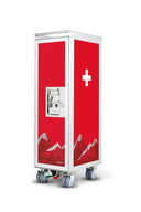 A red and white medical storage cabinet on wheels, featuring a Swiss cross symbol and a mountain graphic on a clean white background.