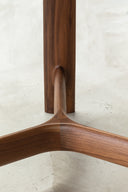 River table base detail showing the sculptural three-way wood joint