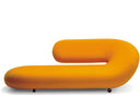 A modern curved lounge chair in bright orange fabric, shown from a side profile against a plain white background.