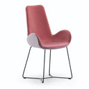 A modern dining chair with a dusty rose pink velvet upholstered seat and back, a light gray side accent, and a black metal wire frame, shown on a plain white background.