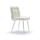 Fasem Avion upholstered dining chair in white bouclé on a neutral white studio background