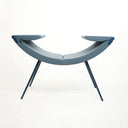 Luxy Clop lounge chair in blue upholstery on dark tapered steel legs, studio side profile