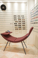 Clop by Luxy in burgundy upholstery used as sculptural lounge seating in an eyewear showroom