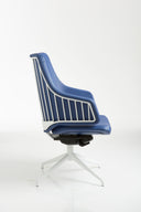 Italia IT10 by Luxy, side view of blue upholstered seat and visible steel frame with four-star base