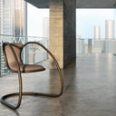 Timeless chair by Luxy with tan seat and sculptural steel frame in modern loft interior