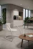 Timeless white upholstered cantilever chair by Luxy in contemporary living-room setting