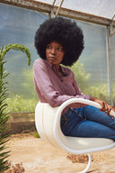 Luxy Timeless lounge chair detail showing upholstered backrest, steel support and sitting posture