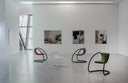 Luxy Timeless cantilever lounge chairs in a contemporary gallery with several upholstery and painted-frame combinations