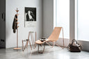 Midj Apelle Tree wood coat rack beside matching hide-leather lounge chair and side tables in contemporary interior