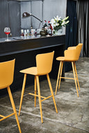Midj Calla M PP yellow counter stools with four metal legs and polypropylene seats at a modern bar