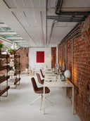 Midj Dalia S X47 TS swivel side chairs with four-spoke bases in a brick-walled contemporary office
