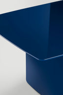 Close-up of blue Midj Foil dining table, showing the knife-edge tabletop and sculptural blue metal base