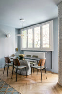 Midj Joe S M TS L Side Chairs in a dining room with a black table and light blue walls