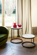 Midj Joint nesting coffee tables with metal ring bases and light round tops beside a tall window
