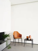 Midj Lea CT-S compact coffee table beside a cognac upholstered chair in a bright minimalist interior