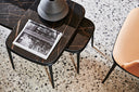 Overhead detail of the dark Midj Lea CT-S coffee table with a book and sculptural ceramics