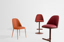 Midj Lea Deluxe SG TS height-adjustable swivel stools with upholstered backs in burgundy beside a coordinating Lea chair