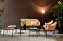 Midj Lea DV M TS coral upholstered two-seat sofa with matching Lea armchairs and ottomans in a contemporary room