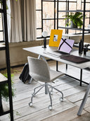 Midj Liu DS LG gray wood-shell office chair with metal caster base at a workstation in an industrial loft