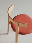 Midj Maya S L TS curved light-wood dining side chair with coral red channel-stitched upholstered seat, close-up