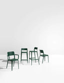 Midj Nene polypropylene chair family with dark green counter stools and side chairs in a product studio