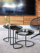 Midj P47 coffee tables with black tabletops and loop bases of varying heights in a modern living room