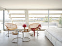 Midj P47 metal coffee tables between P47 lounge chairs in a bright penthouse living room