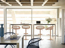 Midj P47 SG TS CU adjustable swivel stools with leather lattice backs and round pedestal bases along an office bar