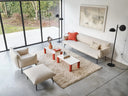Two Midj Paw coffee tables with white tops and red legs in a light-filled contemporary lounge