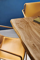 Close-up of a Pechino Dining Table by Midj featuring a natural wood live edge tabletop