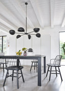 Midj Strike P L chairs with black wire back and wood legs in a modern dining interior