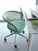 Midj P47 DP TS CU office armchair with green leather lattice seat, rolling five-spoke base, in a modern workplace