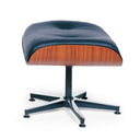 A modern lounge ottoman with a tufted dark blue leather cushion, a warm wood-grain side panel, and a black metal swivel base on a white background.