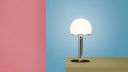 Wilhelm Wagenfeld WA 23 SW table lamp shown in room setting