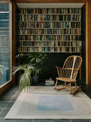 Gray Instrumentation wool rug styled by a bookshelf
